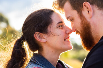 Happy smiling couple with noses touching close together