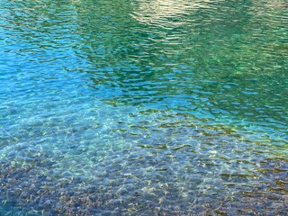 Aqua sea crystal clear water turquoise glittering surface.