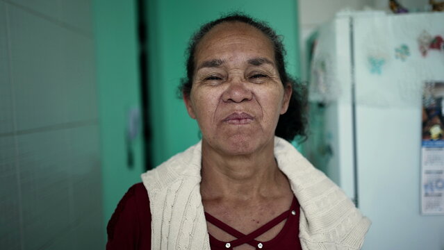 A Senior Hispanic Woman Portrait Face Looking At Camera With Serious Expression