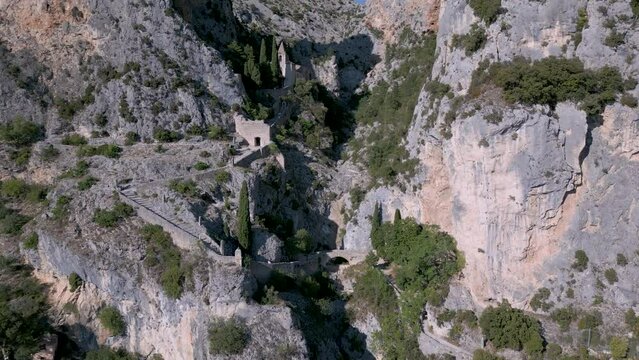 Flying towards limestone cliffs over Moustiers-Sainte-Marie village in France