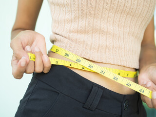 Waist woman with tape measure. body shape slim fit young girl. authentic skin tan. shapely, diet,...