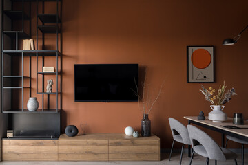 Television screen on orange wall