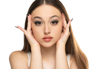 Young beautiful young tightening her face skin with her palms on a white background