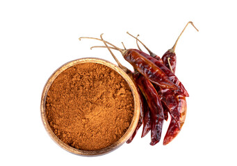 Top view of red hot capsicum and ground pepper in a wooden bowl on a white background.