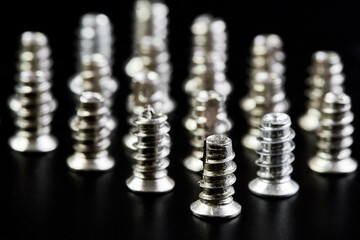 A group of Small bolts for computer equipment and computer assembly on black background