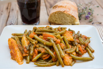 traditional Greek food, green beans, onion and potatoes stewed in tomato, herbs and olive oil, fasolakia ladera in Greece