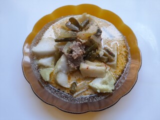 Yummy vegetable lontong with coconut milk sauce on a plate top view on a white background. homemade food background concept, handmade, breakfast, lunch, dinner, eat, eating, restaurant, food recipe