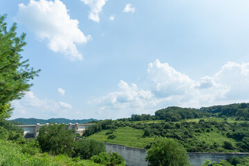 Fototapeta na wymiar Natural landscape around dam sluice gate under blue sky. sunny day