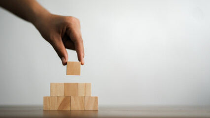 GDP, symbol of gross domestic product Businessman holding a wooden block with an icon saying 'GDP' copy space. Business and GDP growth. Gross domestic product concept.