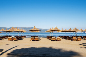 Beach umbrellas from the sun and sun loungers on the beach.