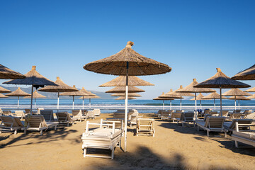 Fototapeta na wymiar Beach umbrellas from the sun and sun loungers on the beach.