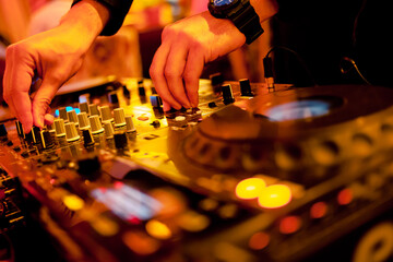 The DJ's hand on the DJ mixer. Dj on the turntables. DJ's hand on a DJ mixer close-up