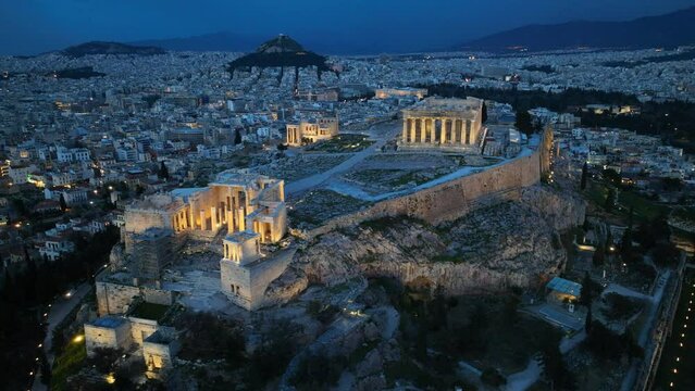 Night drone view of downtown Athens, night view of Acropolis in Athens, aerial view of illuminated Parthenon in Athens in the evening, unesco heritage site in Greece