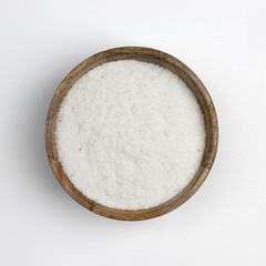 white sea salt in a wooden bowl isolated on white
