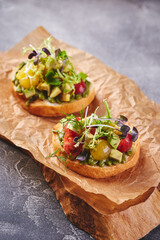Assorted bruschettas with avocado. Appetizing bruschetta. Variety of small sandwiches or crostini. Traditional italian appetizer or snack, antipasto