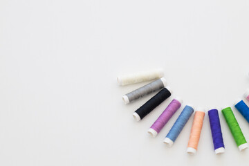 top view of bright and colorful threads on white background