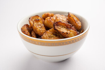 Deep fried ripe plantain slices or pake kele fried chips in a bowl