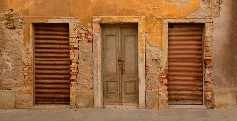 Three old doors in a derelict building in the medieval centre of Izola on the Slovenian coast
