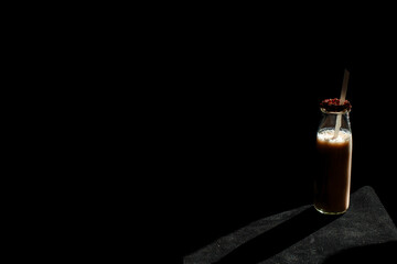 Obraz premium Coffee bottle isolated black background.