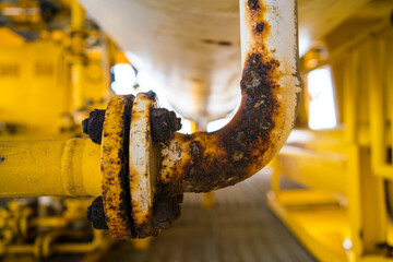 Steel pipe with blister paint, rust paint peeling off against the surface of the pipe.
