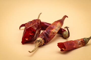red dried chillies cut on orange background