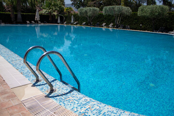 View of the tropical garden and swimming pool with sun loungers for relaxation. Take the ladder...
