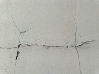 Fototapeta premium Broken cracked damaged cement wall surface in need of repair old texture background. affected by the earthquake