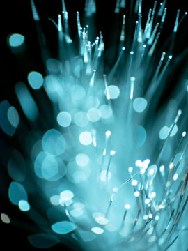 Optical fiber network cable on black background, abstract light sparkler