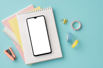 Back to school concept. Top view photo of school supplies smartphone over note pads ruler adhesive...