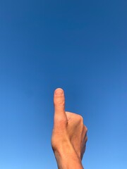 Thumb up to the sky with lots of copy space