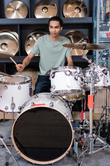 African american customer playing drums in music store.