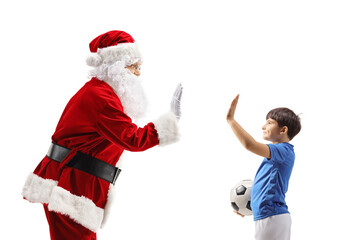  Santa gesturing high-five with a boy in a football outfit