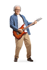 Full length portrait of a mature man with headphones and electric guitar