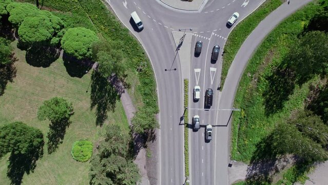 Aerial view of the street, roundabout, and pedestrian bridge over the crossroad in Finland