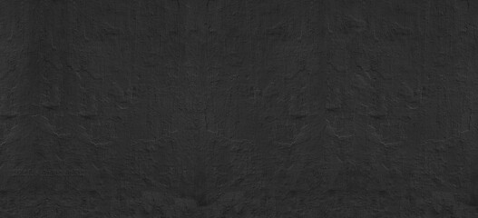 Black painted old concrete wall wide texture. Dark rough textured cement surface. Abstract gloomy grunge widescreen background