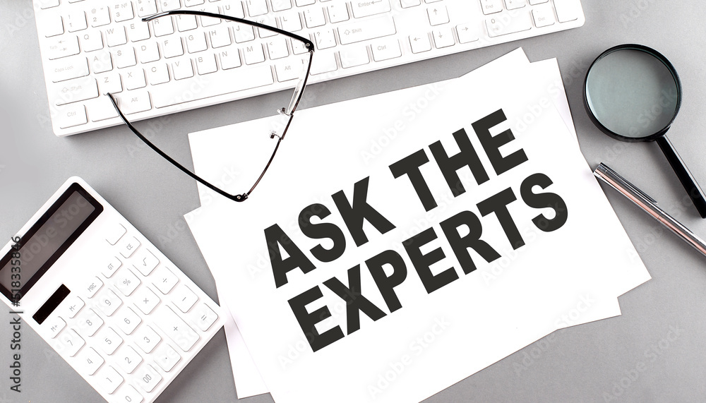 Poster ask the expert text on paper with keyboard, calculator on grey background