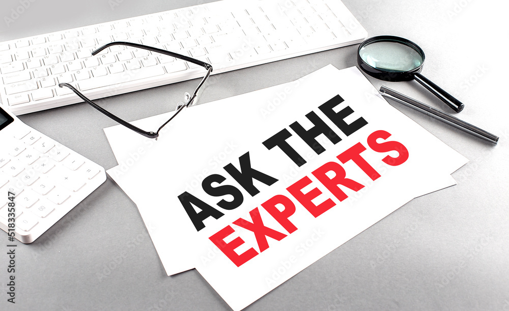 Poster ask the expert text on a paper with keyboard, calculator on grey background