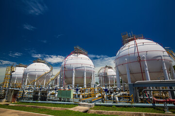 White spherical propane tanks containing fuel gas