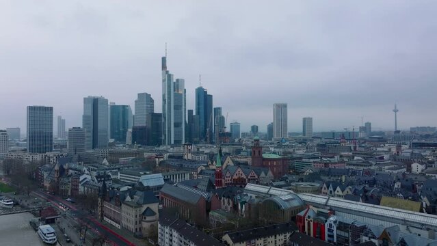 Fly over historic city centre. Cityscape with group of modern high rise office buildings on cloudy day. Frankfurt am Main, Germany