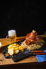 rustic pork knuckle with sauerkraut, sweet mustard and fried potatoes