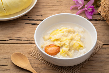 Thai sweet food,Cooked sticky rice in sweet coconut milk with Durian fruit in white bowl,popular dessert in Thailand
