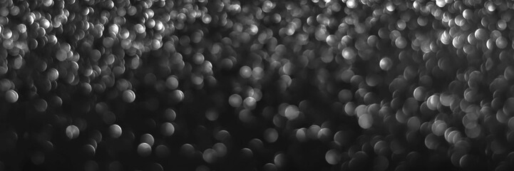 Gray black sparkling glitter bokeh background, christmas abstract defocused texture. Holiday...