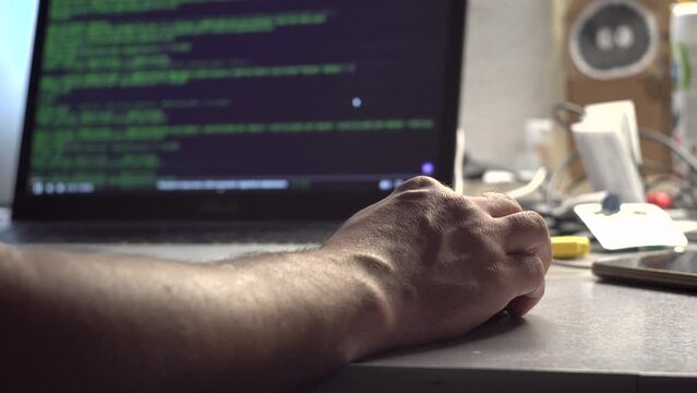 Male programmer. Human hands. Laptop on the table. Program code on the screen. Computational operations. Application programming. View code. Tester. IT-specialist. Close-up.