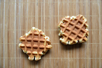 Golden delicious viennese waffles wooden. Wooden background. Raspberry isolated. Gourmet food.