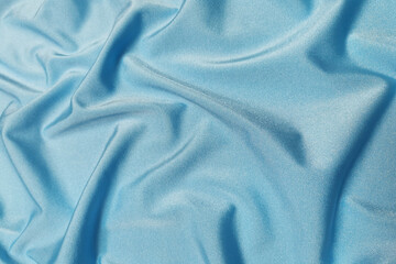 Blue supplex crumpled or wavy fabric texture background. Abstract linen cloth soft waves. Silk fabric. Smooth elegant luxury cloth texture. Concept for banner or advertisement.