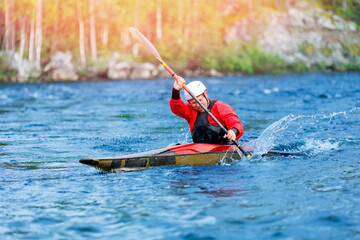 Whitewater kayaking, extreme sport rafting. Guy in kayak sails mountain river