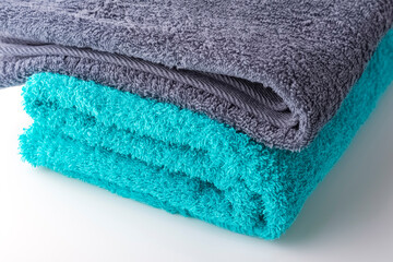 A stack of bath towels, on a white background. Close-up