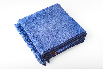 Terry bath towels of blue color, on a white background. top view
