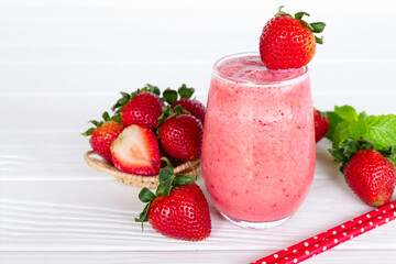 Strawberry yogurt fruit juice smoothie pink colorful fruit juice milkshake blend beverage healthy high protein the taste yummy In glass drink episode morning on white wood background.
