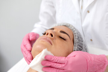 Fototapeta na wymiar Woman having cleaning facial treatment in spa